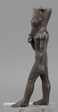 Figurine of the god Amun; maker, Amun mythology; Egyptian deity male figurine; once held a khepesh;