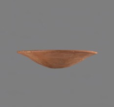Bowl. Low bowl with irregular, strongly flaring walls and a rounded bottom. Rounded rim, slightly