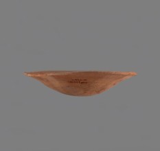 Bowl. Low bowl with irregular, strongly flaring walls and a rounded bottom. Rounded rim, slightly