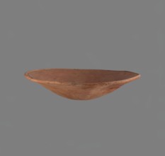 Bowl. Low bowl with irregular, strongly flaring walls and a rounded bottom. Rounded rim, slightly