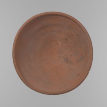 Bowl. Shallow, rounded, asymmetrical bowl with a rounded, flaring, irregular rim. Surface level;