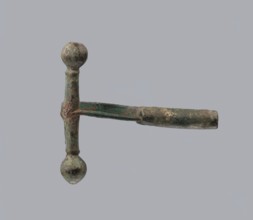 Onion-shaped fibula, Italy. Bronze fibula with hinged structure: an arched ring made from a