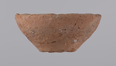 Bowl, probably votive, with a conical shape and a flat bottom. Straight rim, slightly curled