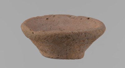 Bowl, probably votive, conical shape with a flat bottom. Irregular walls; straight, slightly