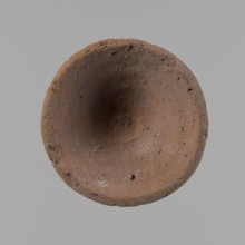 Bowl, probably votive, conical shape with a flat bottom. Irregular walls; straight, slightly
