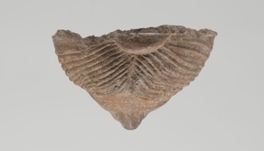 Female votive head. Female head with long, straight hair falling to the shoulders. Neck partially