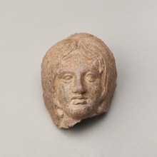 Female votive head, Female head with long, straight hair falling to the shoulders. Neck partially