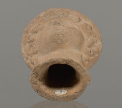 Female votive head, Female head in a wreath, slightly tilted to the right shoulder. Under the