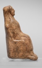 Figurine of a seated woman. Figurine of a woman sitting on a throne with her hands placed on her