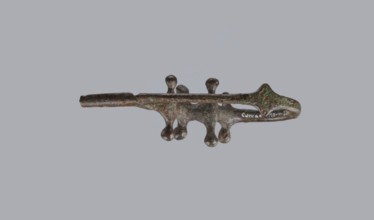 Fibula a Drago, One-piece bronze fibula with an arched ring of circular cross-section bearing 4