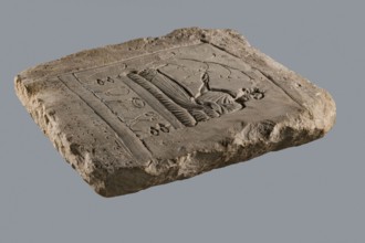 Rectangular tombstone depicting a young man in a long robe in a semi-reclining position on a bed