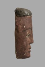 Sarcophagus mask with a flat fragment of a wig above the forehead. Elongated face, painted brown,