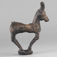 Emblem in the form of a figurine of a standing goat figurine of a standing gazelle with slightly