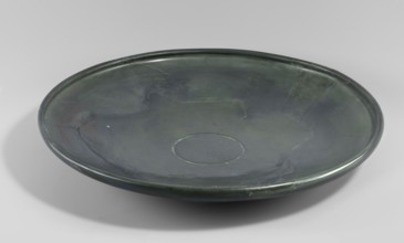 Plate, shallow stone plate with a convex bottom and a strongly flaring bowl; wide rim bent inward.