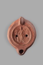 Lamp decorated with a representation of the goddess Roma with an eagle and a palm branch; at the