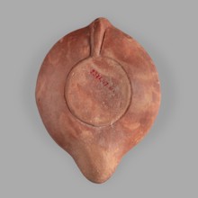 Lamp decorated with a representation of the goddess Roma with an eagle and a palm branch; at the