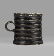 Dice cup. Small cup with a flat slightly concave bottom, slightly tapered walls, distinct rim and