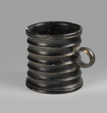 Dice cup. Small cup with a flat slightly concave bottom; walls slightly tapered; distinct rim and