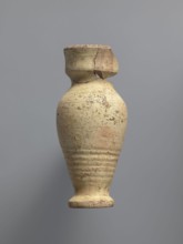 Water vessel qulla. Ovoid with elongated belly; edge of foot protrudes outward. Short, wide neck