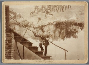 Michal Sozanski standing with a palette on a scaffolding next to a part of the canvas depicting the