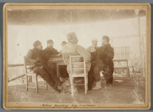 Six painters seated at a table on the central platform in the rotunda painting the Raclawice