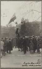 Planting a white-and-red flag in front of the Governor's Palace by a student of the University of