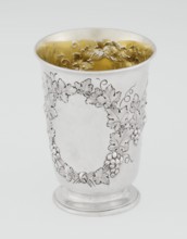 Conical mug, silver on circular foot; belly decorated with relief vine wreaths, one with an English
