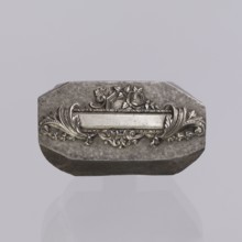 Jewellery die, Approximately hexagonal die with a relief rectangular reserve enclosed at the ends
