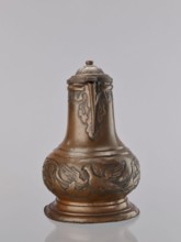 Jug. On a circular, stepped base, the body bulges in the lower part, decorated with a repoussé