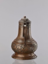 Jug. On a circular, stepped base, the body bulges in the lower part, decorated with a repoussé