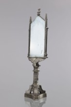 Candle screen. On a three-sided plinth, on a tripod decorated with oak branches, with a hexagonal