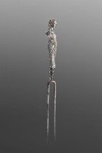 Fork. Two-pronged steel fork with a silver handle shaped as a full-plastic female herm, decorated