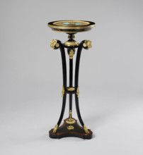 Round table, lacquered black, decorated with gilded cast brass fittings, with a ceramic painted