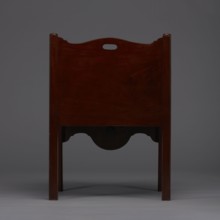 Bedside table with toilet, tambour door in the upper section and a pull-out section below with a