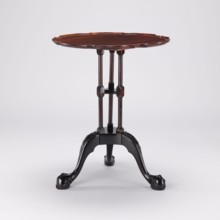 Side table with round top and wavy profiled rim, supported by a shaft of three slender turned