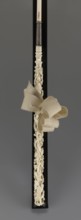 Women's umbrella made of white lace. Its canopy is trimmed with cream silk at the bottom, which
