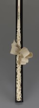 Women's umbrella made of white lace. Its canopy is trimmed with cream silk at the bottom, which