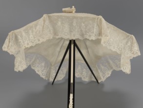 Women's umbrella made of white lace. Its canopy is trimmed with cream silk at the bottom, which