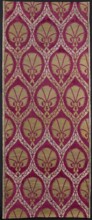 Fabric with a motif of pointed ovals formed from wide ribbons decorated with floral tendrils.