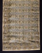 Fragment of a belt with a continuous pattern of alternating silhouetted tendrils with an iris motif