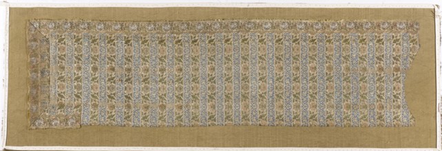 Fragment of a belt with a continuous pattern of alternating silhouetted tendrils with an iris motif