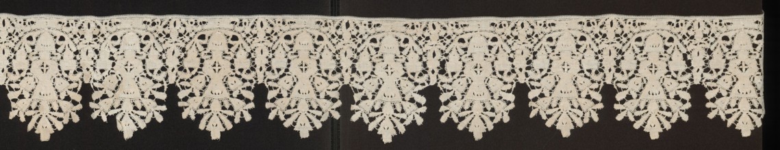 Lace fragment, floral ornaments. Lower edge serrated. In each oval there is a vase of flowers.