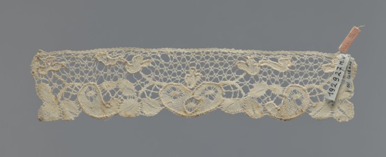 Cuff, repossession provenance; fashion accessory cuff; lace; pattern of leaves and palmettes at the