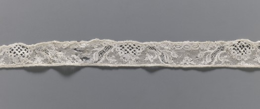 Lace fragment, floral ornaments, Malines lace, pattern with motifs of winding ribbons, flowers, and