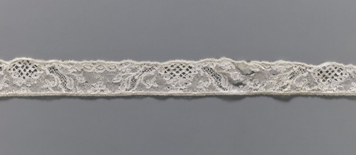 Lace fragment, Floral ornaments. Malines lace. Pattern with motifs of winding ribbons, flowers, and