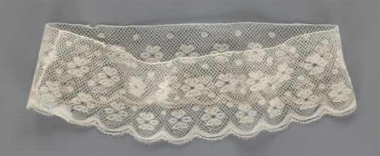 Fragment of lace, lace. A section of a belt sewn into a closed circle with one-sided arched