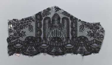 Lace fragment, plant ornaments. Preserved ruffle fragment features a symmetrical ornament of a