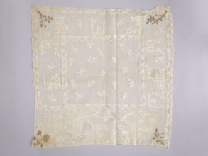 Tablecloth. Embroidered tablecloth; white embroidery on white mesh with gold-thread accents in