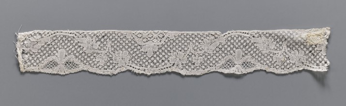 Lace fragment, mid-18th century. Binche lace, width 3.8 cm, length 30.5 cm. A tendril motif at the