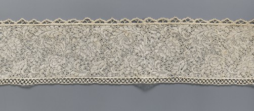 Fragment of bobbin lace with plant ornaments, 18th century, Flanders;, width 7 cm, length 74 cm., A